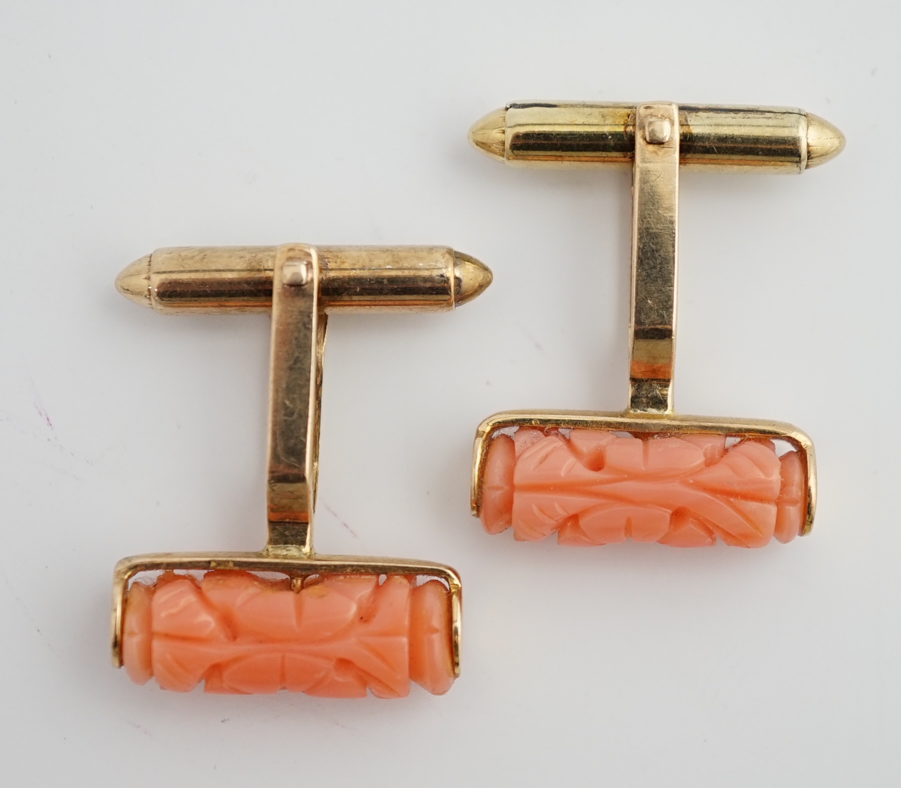 A pair of 9k gold and carved coral set cufflinks